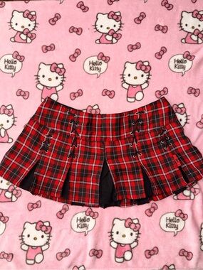 Tripp NYC Red and Black Plaid Pleated Mini Skirt with Lace-Up Detail